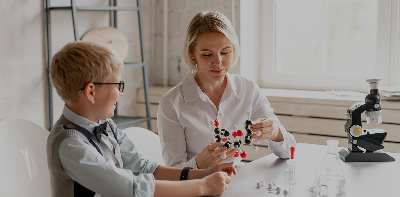 Female science tutor in Dallas studying chemistry with student